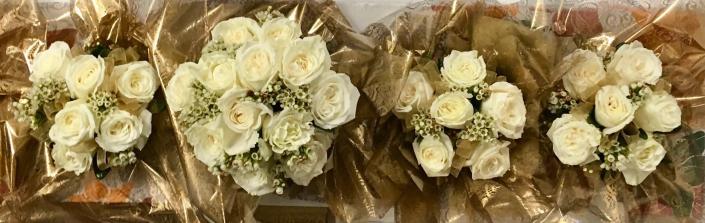 Simple white garden rose and white wax flower bouquets.