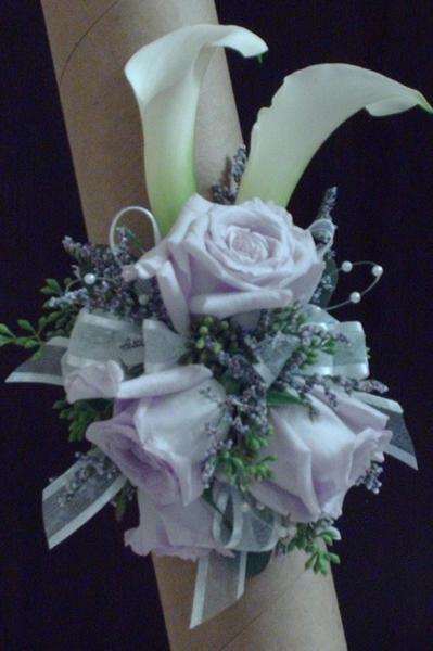 White calla lily's, lavender roses, filler, greenery, and ribbon