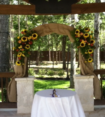 Burlap arch,accented with sunflowers, roses, and viking poms