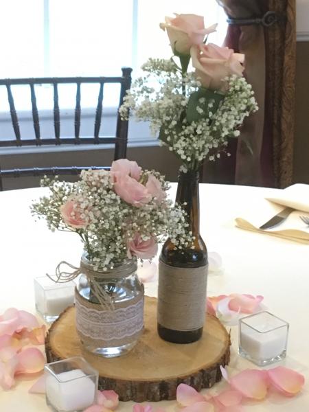 Mason jar, beer bottle with twine, baby's breath and light pink roses