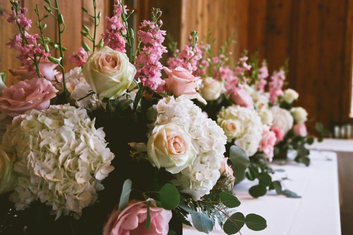Light pink roses, stock, creme roses, white hydrangea, orchids and greenery