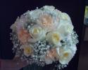 Peach and pale pink carnations, creme roses, and baby's breath