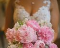 A spring bouquet featuring pale pink peony's, white lilac and dusty miller greenery