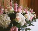 Light pink roses, stock, creme roses, white hydrangea, orchids and greenery