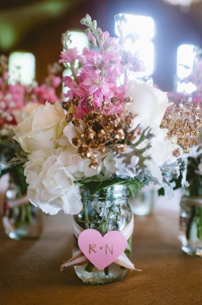 White hydrangea, roses, pink stock, and gold baby's breath in mason jar's