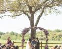 Rustic arch with floral accents in lavender and purples. A mix of roses, carnations, mums, alstromeria, purple statice and babys breath.